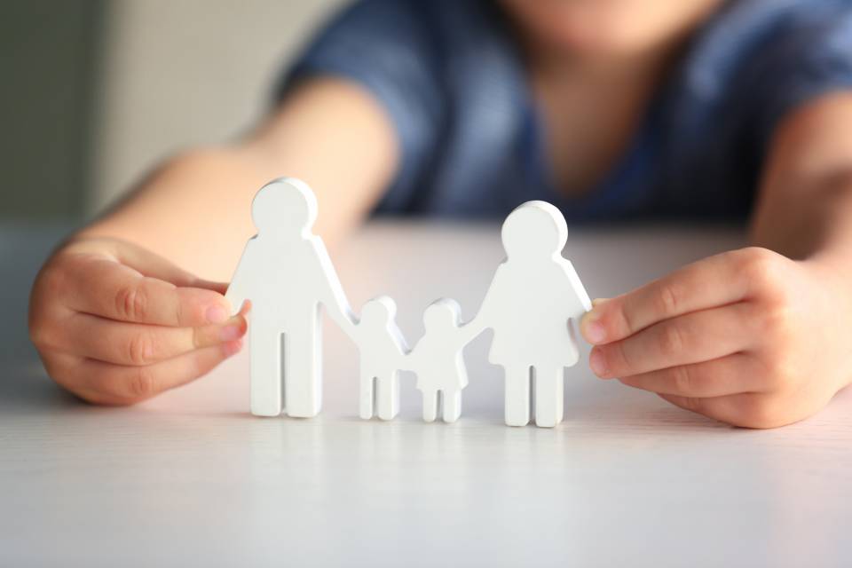 girl holding family cut out