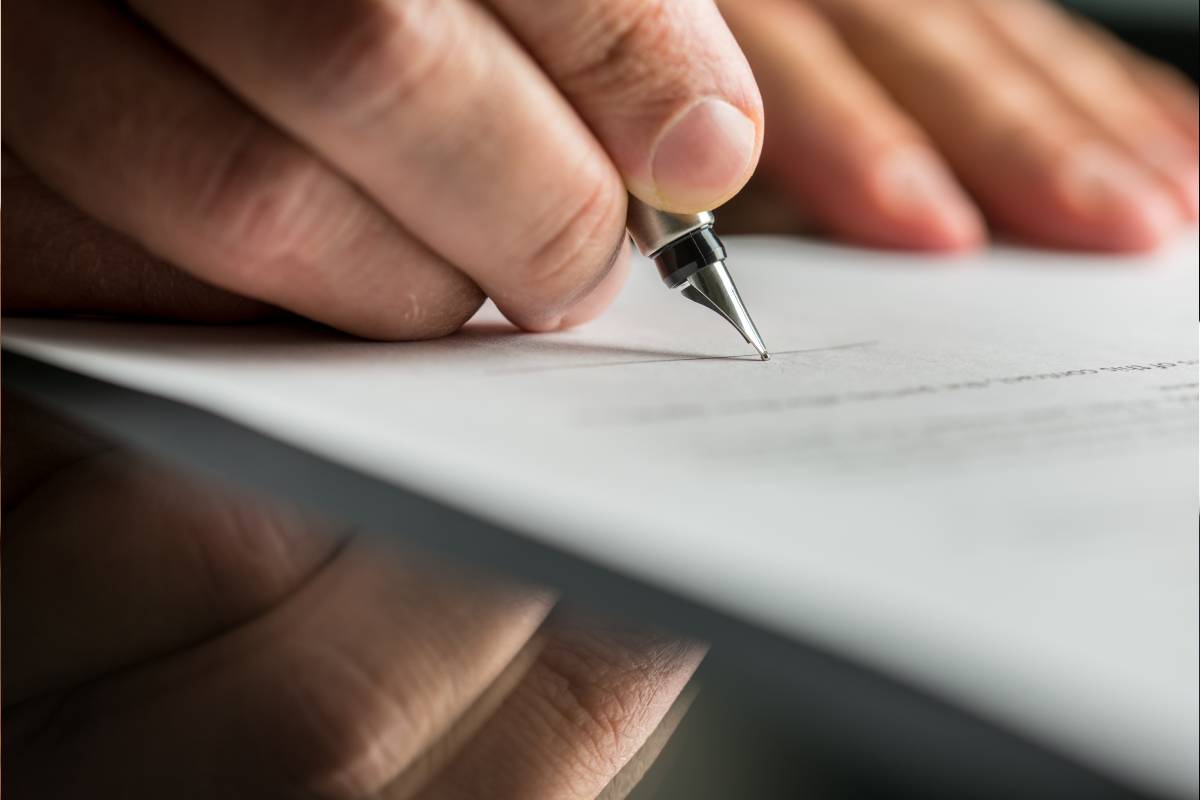 man signing the paper